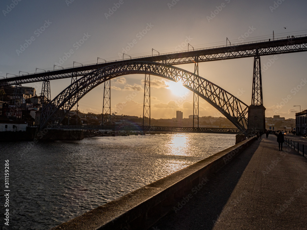 Porto, Portugal. 15 November 2019. Autumn sun setting over Douro River behind Ponte Luis I.