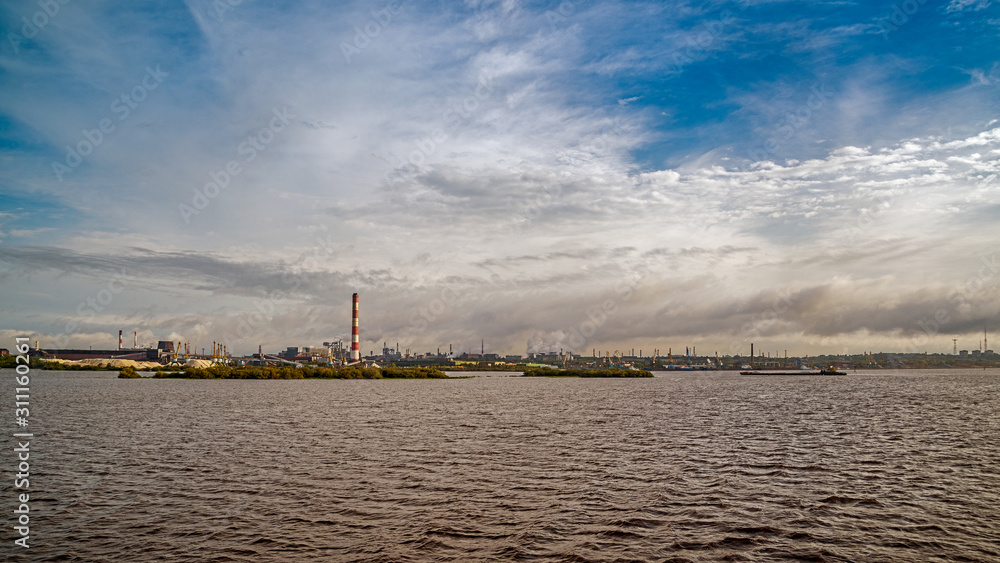 Sailing on the northwest river along the territory of metallurgical plant
