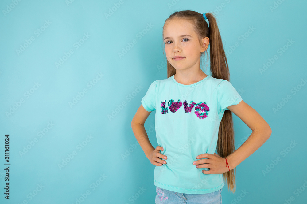Fashionable teenager girl in blue t-shirt gesticulates, portrait isolated on blue background Fashionable teenager girl in blue t-shirt gesticulates, portrait isolated on blue background