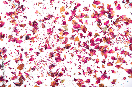 Background made of dried red rose petals isolated on white.