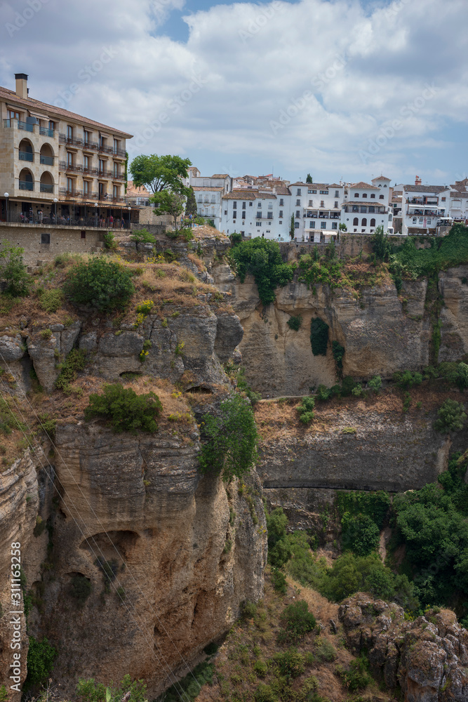 Ronda, Spain, a city in the Spanish province of Málaga, stand along a cliff on a sunny, summer day.