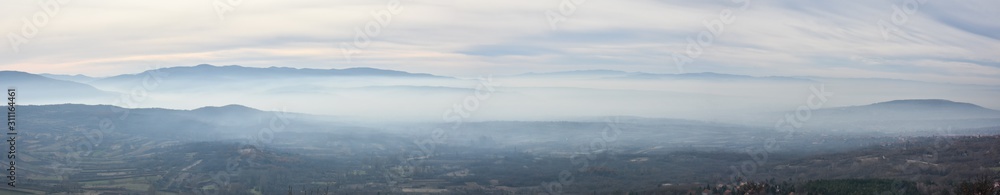 Environment pollution, foggy landscape of valley. Fog and pollution above the city of Nis, You can't see the city from smog