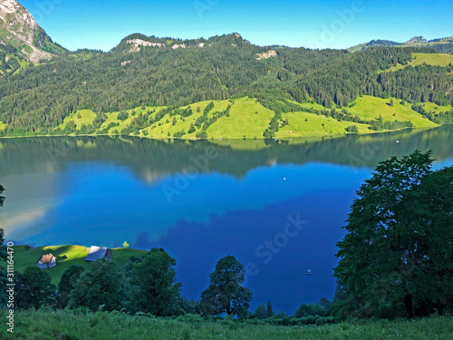 Fairytale idyllic motif from the Wagitalersee or Waegitalersee alpine Lake in the valley Wagital (Waegital), Innerthal - Canton of Schwyz, Switzerland photo