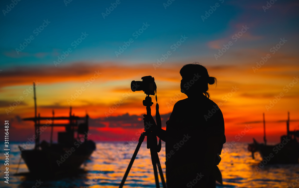 Fototapeta premium Silhouette of photographer with sunset time.
