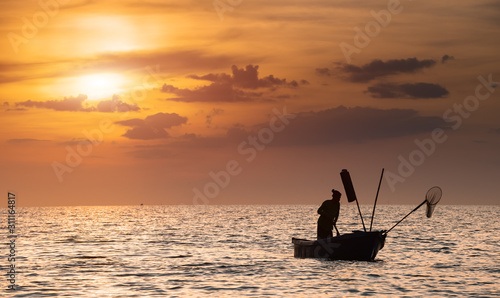 Silhouette of fisherman with warm and sunset time.