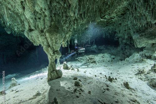 A DPV cave diver swims in the Chan hal cave (Mexico)