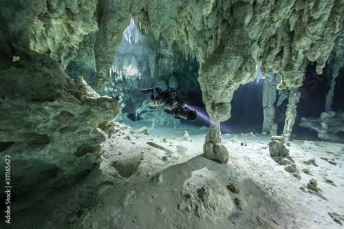 A DPV cave diver swims in the Chan hal cenote (Mexico)