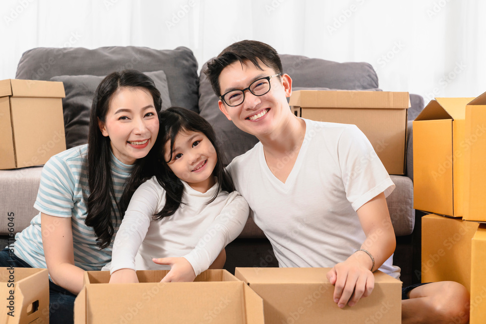 asian happiness family smile and look at camera unpack stuff in new home house moving ideas concept