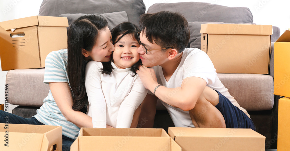 asian happiness family smile amd kissing daughter together while unpack stuff in new home house moving ideas concept asian happiness family smile amd kissing daughter together while unpack stuff in new home house moving ideas concept