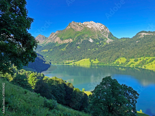 Beautiful view of mountain peaks Turner and Diethelm of over the alpine lake Wagitalersee (Waegitalersee), Innerthal - Canton of Schwyz, Switzerland photo