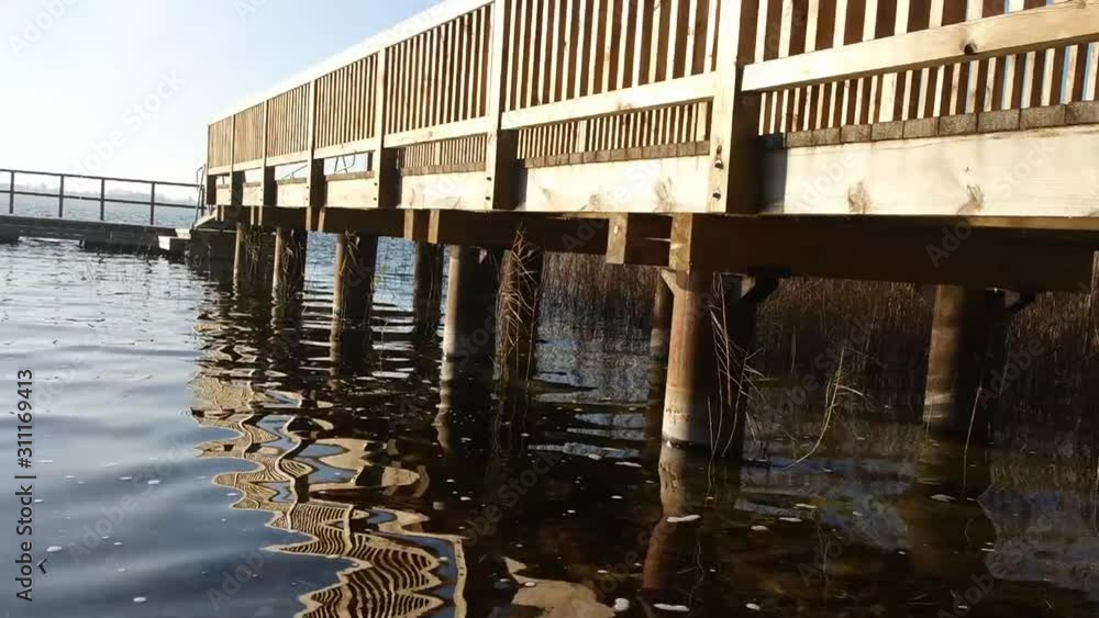 blue water of lake with wooden balls of pier blue water of lake with wooden balls of pier