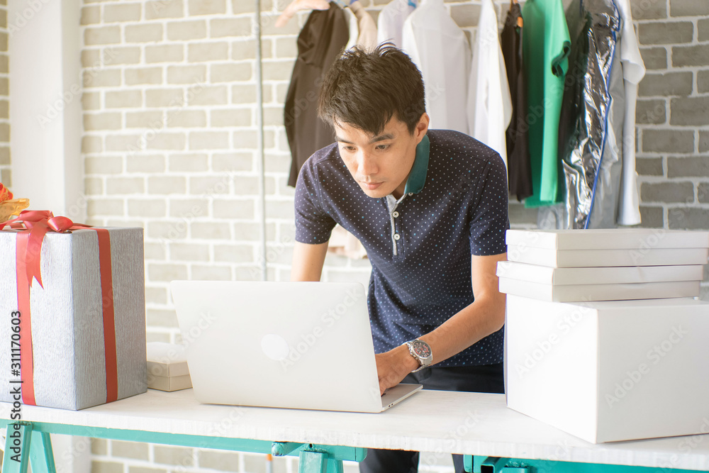 Business entrepreneur asian men online sell of fashion cloth in house Business entrepreneur asian men online sell of fashion cloth in house