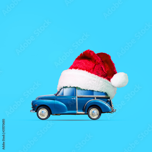 Retro car in Santa's hat on a blue background. Isolated .Christmas. New year background.