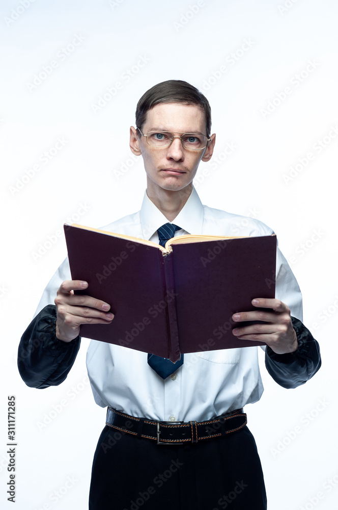 A business man in a tie and glasses with a magazine in his hands on a white, isolated background. A business man in a tie and glasses with a magazine in his hands on a white, isolated background.