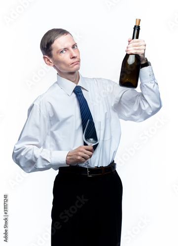 Business man with a glass and a bottle of wine in his hands on a white, isolated background.