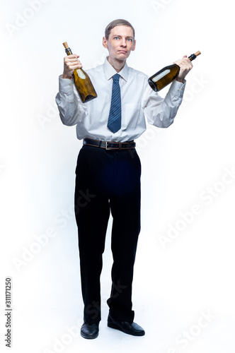 Business man with a bottle of wine in his hands on a white, isolated background.