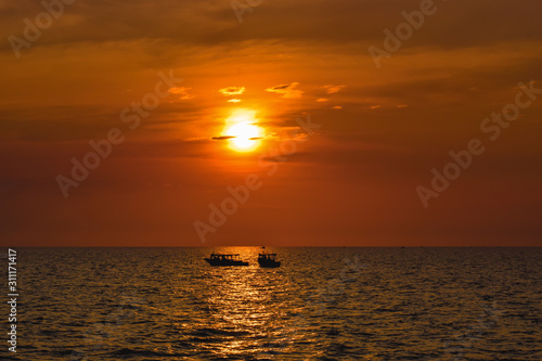 Two Lonely ships on a wide sea during beautiful orange sunset in Asia © MartinZizlavsky