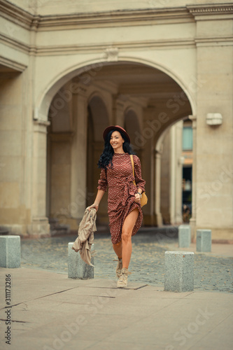 Young woman walking happily on the streets of Bucharest © xpabli