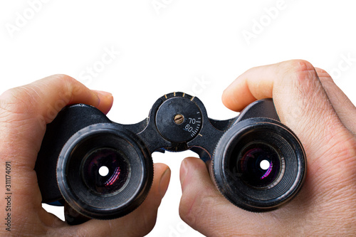 Black vintage binoculars in hands isolated on white.