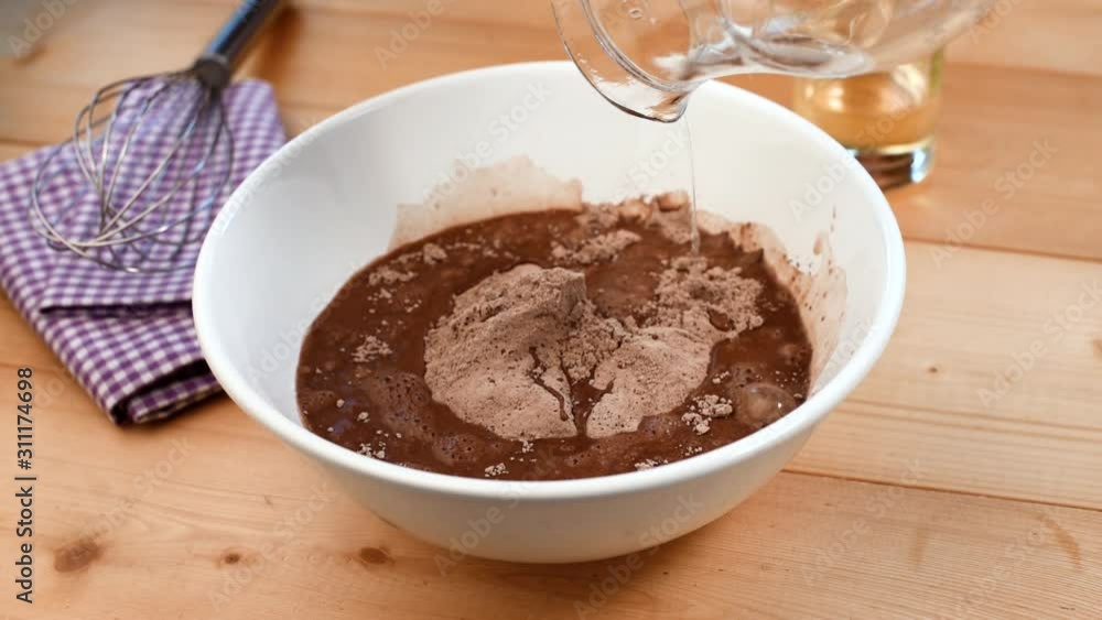 Quick baking cocoa chocolate cake mix. Timelapse of preparing sweet batter for muffins or cake Quick baking cocoa chocolate cake mix. Timelapse of preparing sweet batter for muffins or cake