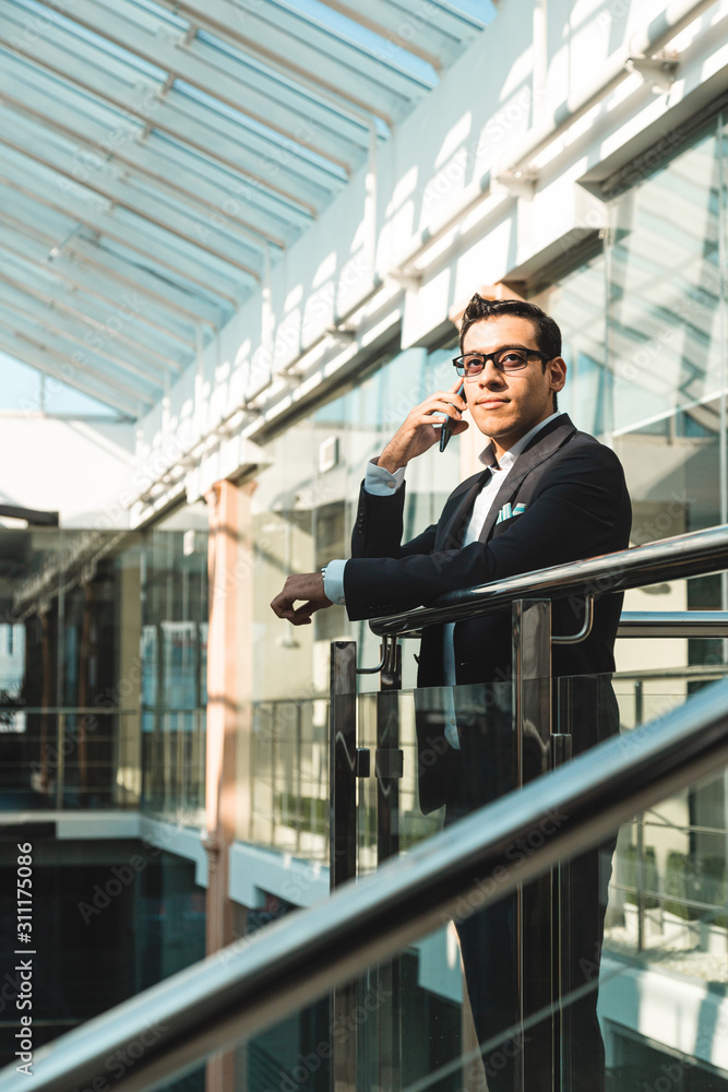 Portrait of a businessman in suit are standing on the background of glass offices. Portrait of a businessman in suit are standing on the background of glass offices.