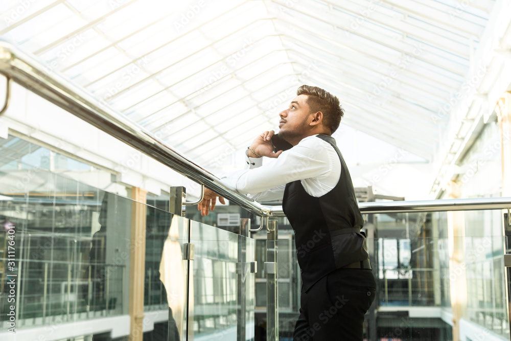 Portrait of a businessman in suit are standing on the background of glass offices. Portrait of a businessman in suit are standing on the background of glass offices.