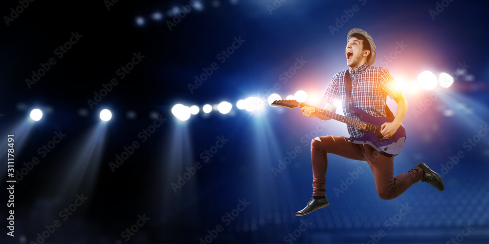 Obraz premium Guitarist at concert. Mixed media