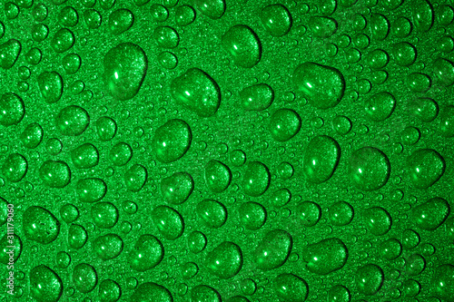 Fotografie A close up abstract macro photo of water droplets on a grey non stick frying pan