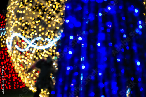 Abstract blur image of Christmas lights in the night. Bright lights for background, xmas holiday texture