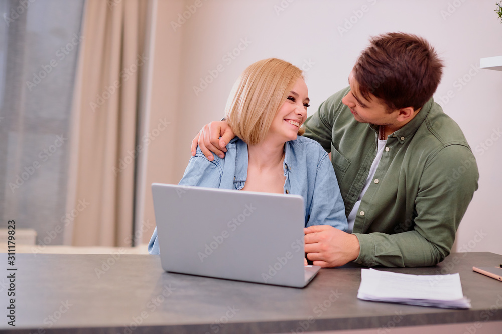young caucasian man and woman checking their bank account on modern laptop, checking their documents and papers, mortgage, expenses, costs and bill concept young caucasian man and woman checking their bank account on modern laptop, checking their documents and papers, mortgage, expenses, costs and bill concept
