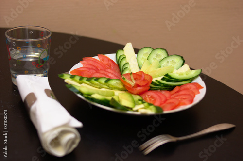 cut vegetables tomatoes cucumbers on the plate