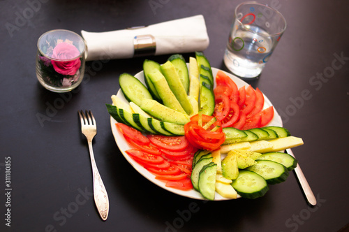 cut vegetables tomatoes cucumbers on the plate