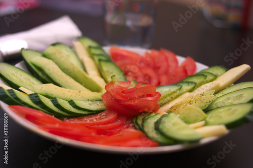 cut vegetables tomatoes cucumbers on the plate