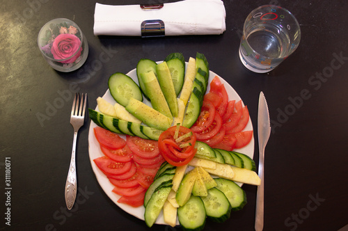 cut vegetables tomatoes cucumbers on the plate