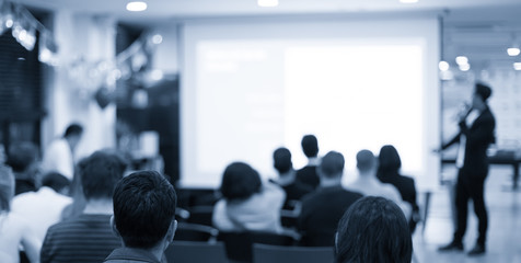Business presentation being given by tech executive. Corporate seminar with expert speaker presenting to people. Man giving speech during lecture. Leadership training coach in workshop.