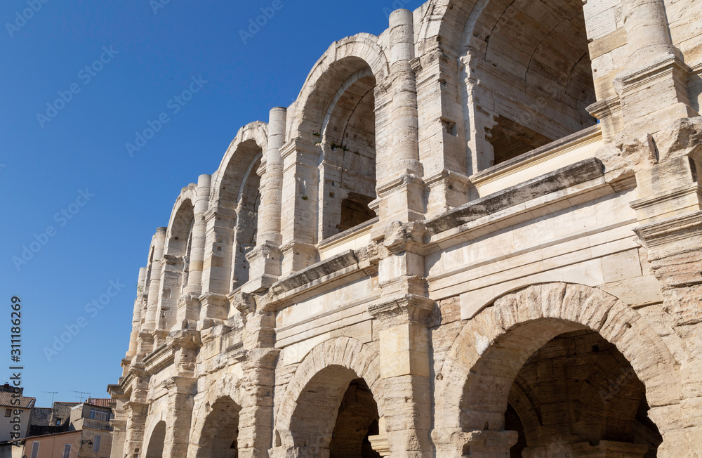 Ancient Roman Amphitheatre in Arles in Provence with blue sky 