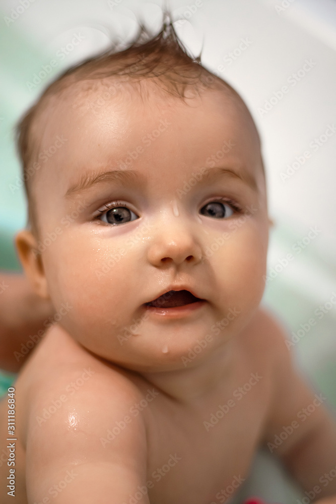 Cute newborn girl bathes in the bathroom Cute newborn girl bathes in the bathroom