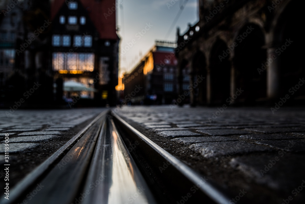 Evening train tracks with blurred background. Tramp trails in the city