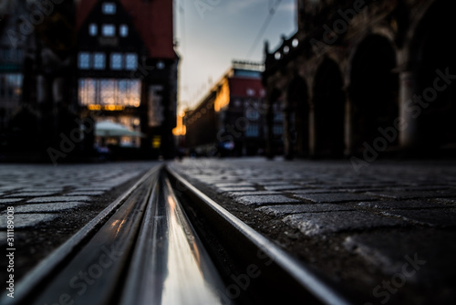 Evening train tracks with blurred background. Tramp trails in the city