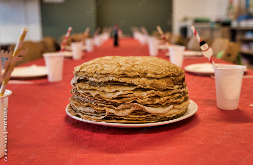 stack of pancakes on a red tablecloth