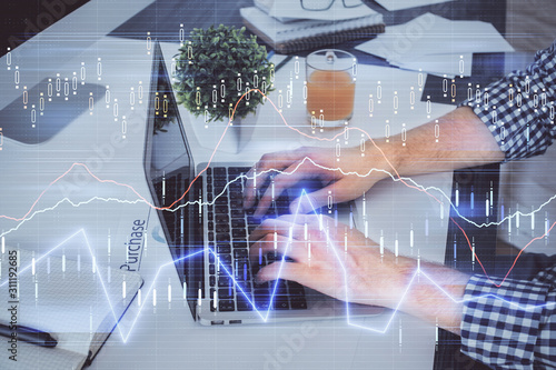 Double exposure of graph with man typing on computer in office on background. Concept of hard work.