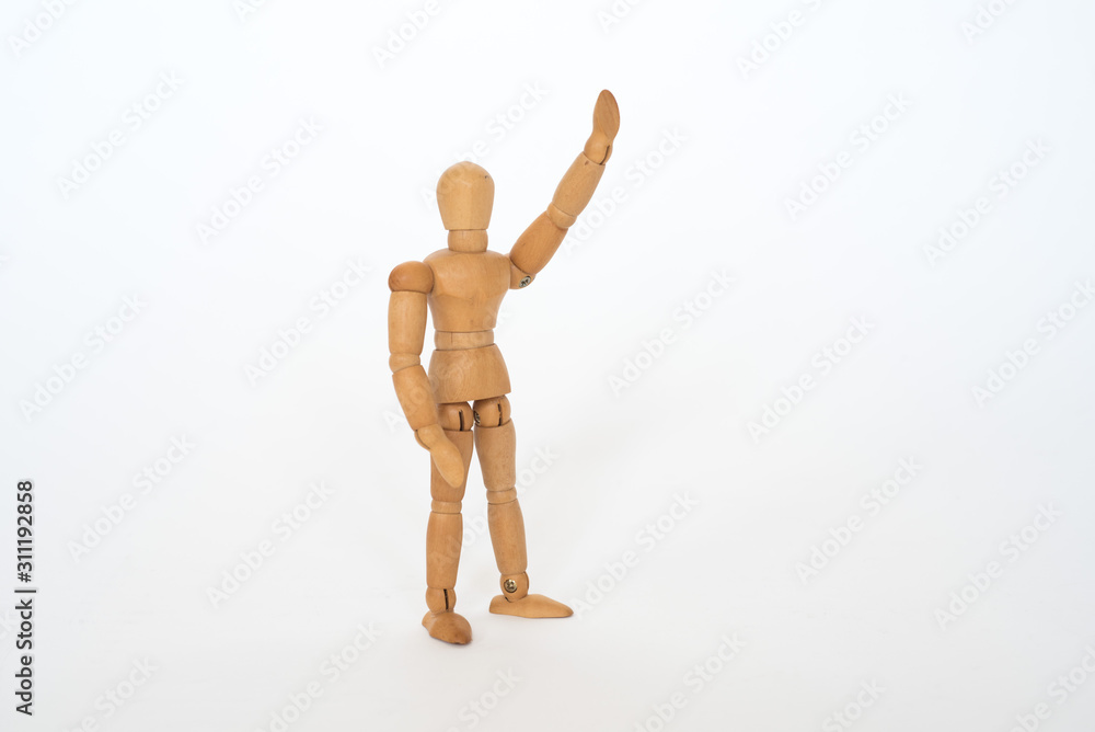 Wooden figure pose raised hand on white background isolated object Wooden figure pose raised hand on white background isolated object