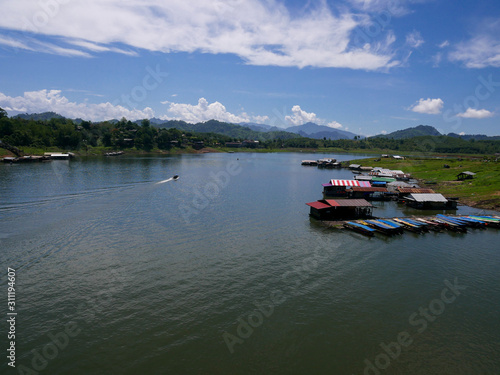 boat on river.Songkalia River, Sangkhlaburi, Kanchanaburi, Thailand. There are boats and houseboat in the river.