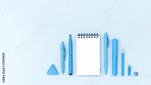 Assorted office and school monochrome blue stationery on pastel trending background. Flat lay with copy space for back to school or education and arts craft concept