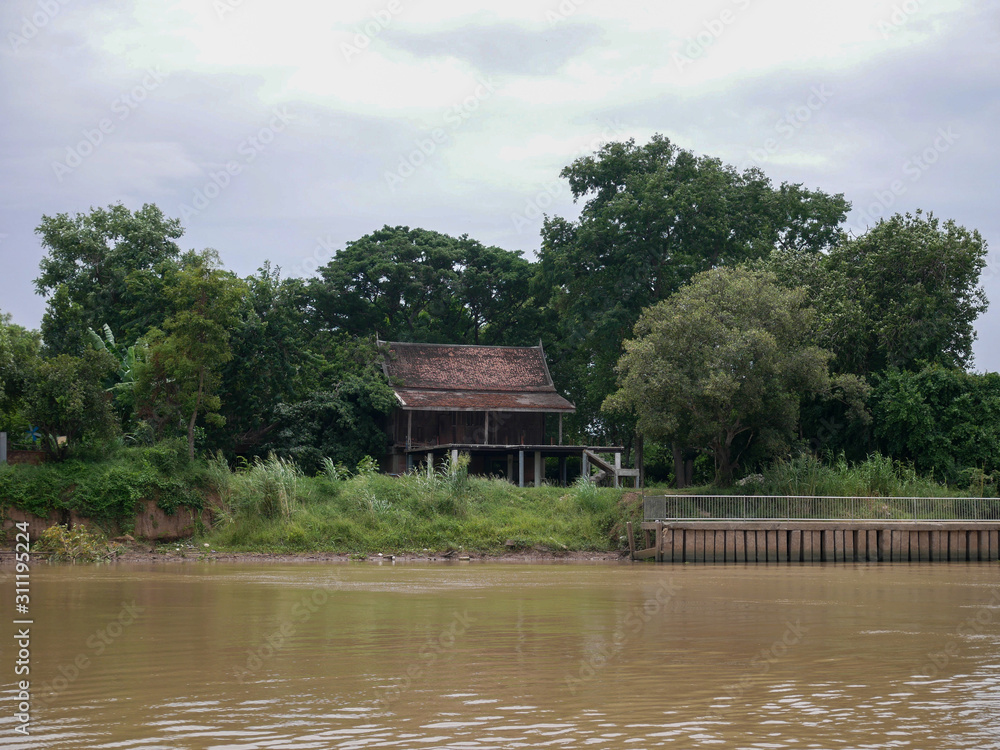 Old Thai style wooden house by the Chao Phraya River