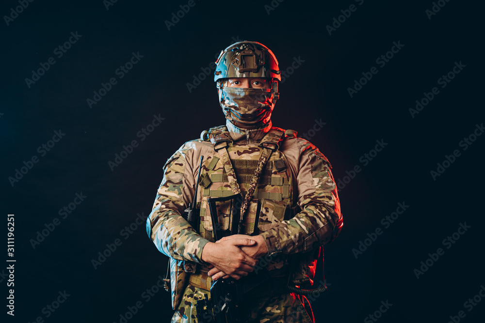 portrait of serious confident brave soldier in army wear, camouflage, isolated over black background. military forces concept portrait of serious confident brave soldier in army wear, camouflage, isolated over black background. military forces concept
