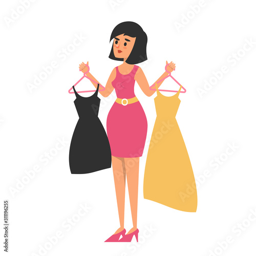 Beautiful young brunette woman choose dress in the shop