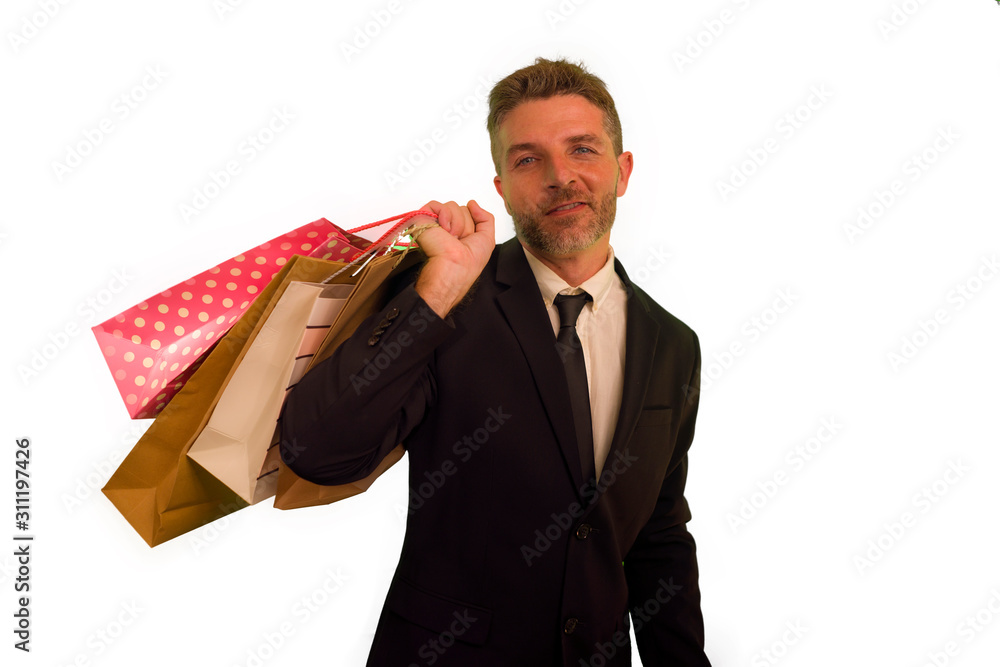 isolated background portrait of young attractive and happy business man in suit and tie holding lot of shopping bags smiling cheerful in sales and opportunity concept isolated background portrait of young attractive and happy business man in suit and tie holding lot of shopping bags smiling cheerful in sales and opportunity concept