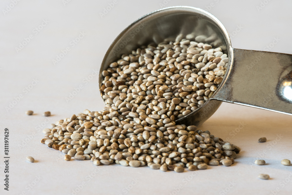 Obraz premium White Chia Seeds Spilled from a Teaspoon