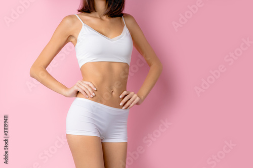 cropped slim beautiful body of young woman wearing underwear and isolated over pink background